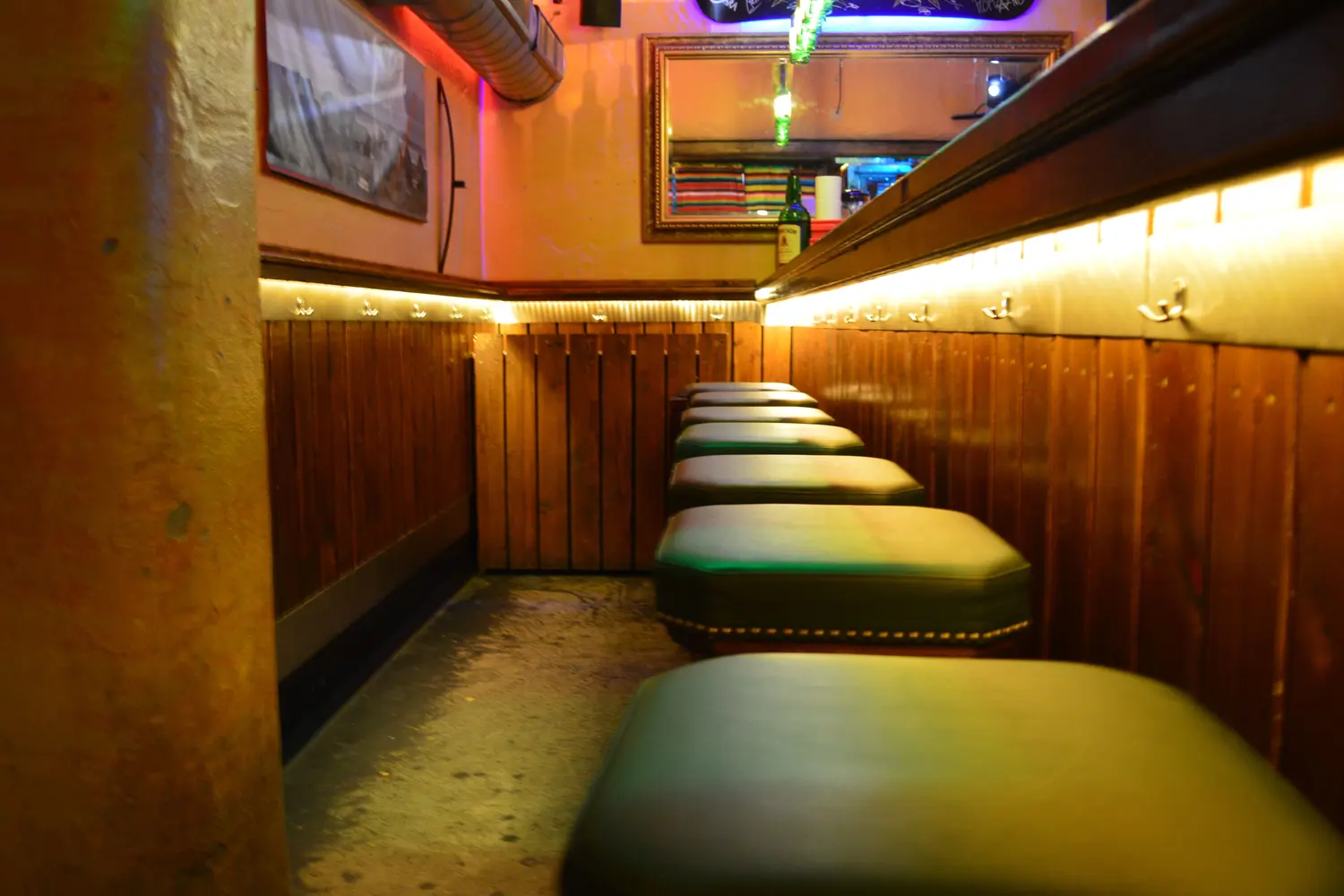 Padded benches along the wooden wall