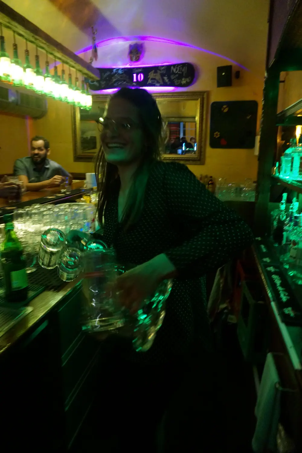 A guest at the counter in green light