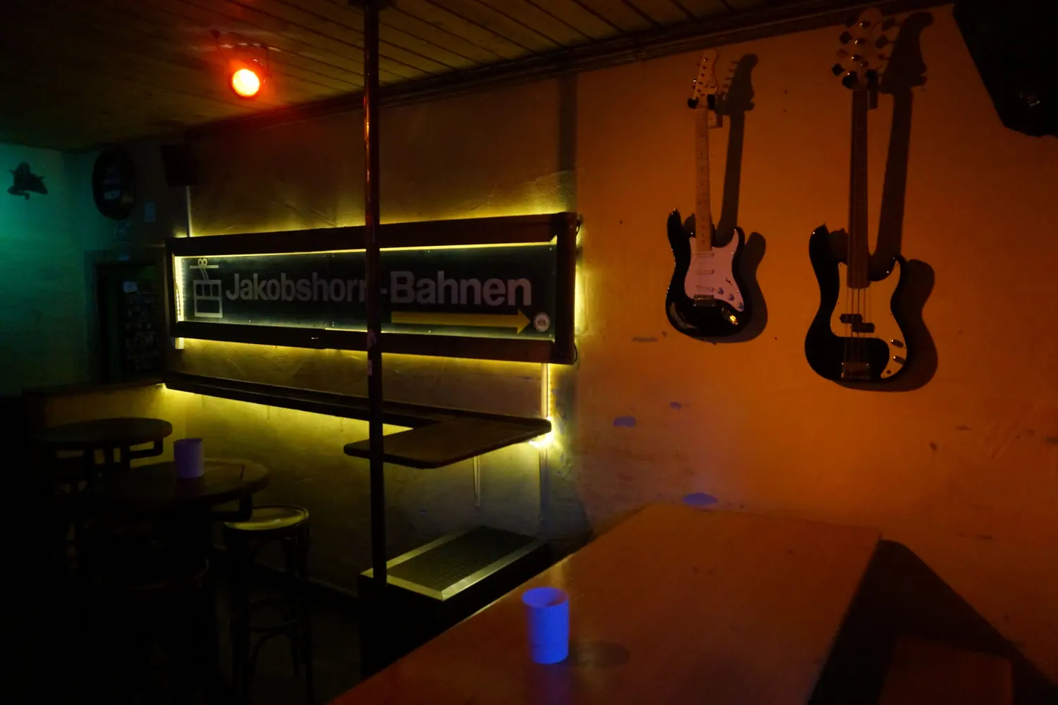 Two guitars on the wall next to the Jakobshorn cable car sign