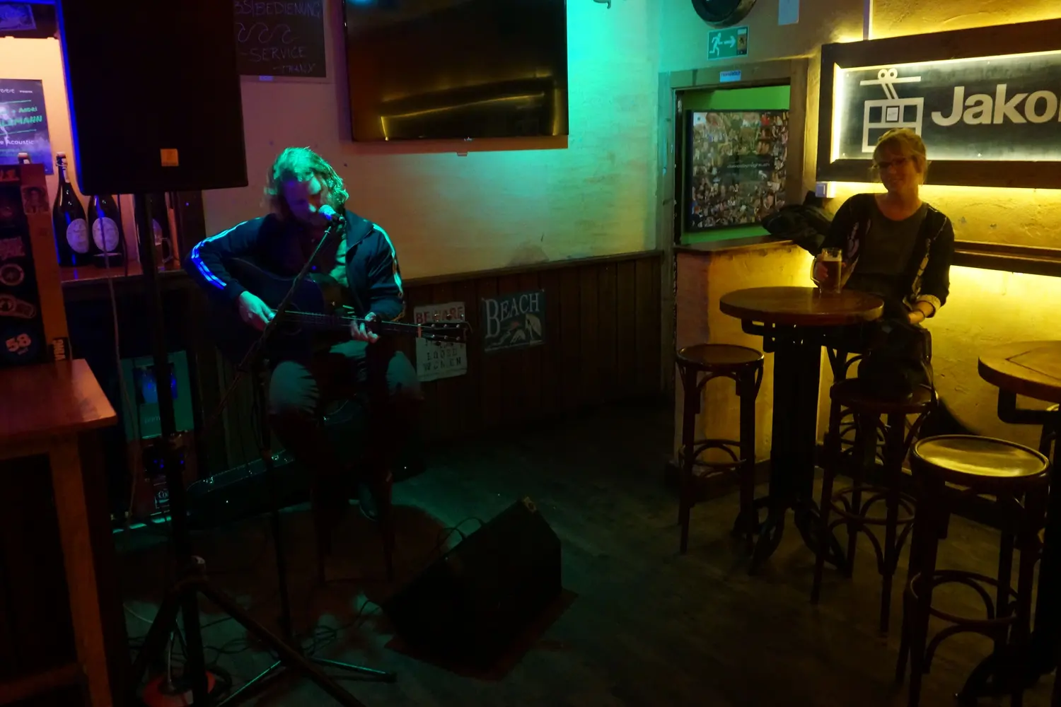 A musician plays guitar in coloured spotlights