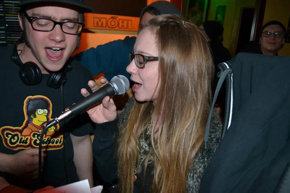 Two guests sing together into one microphone