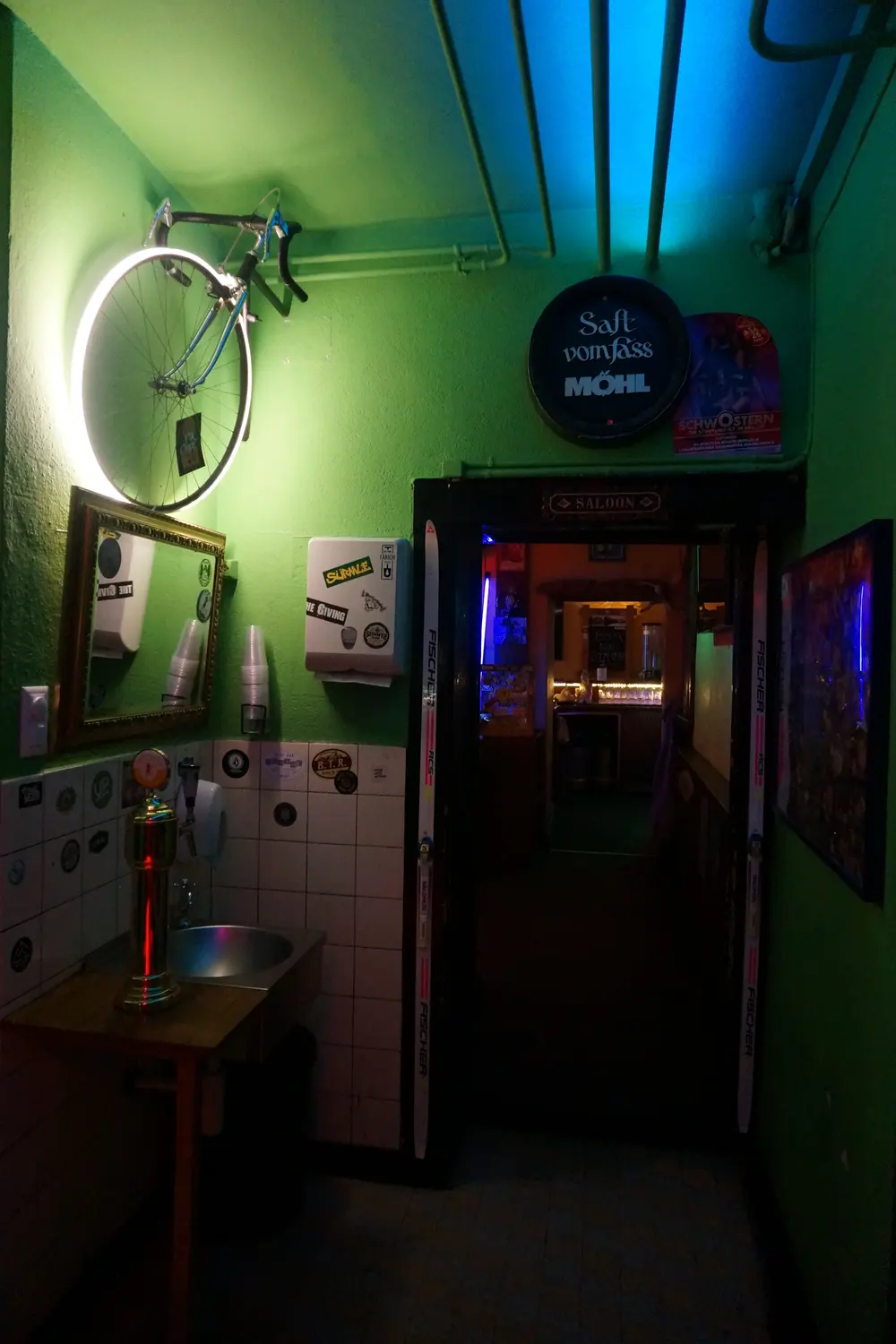 The green washroom with a bicycle on the wall