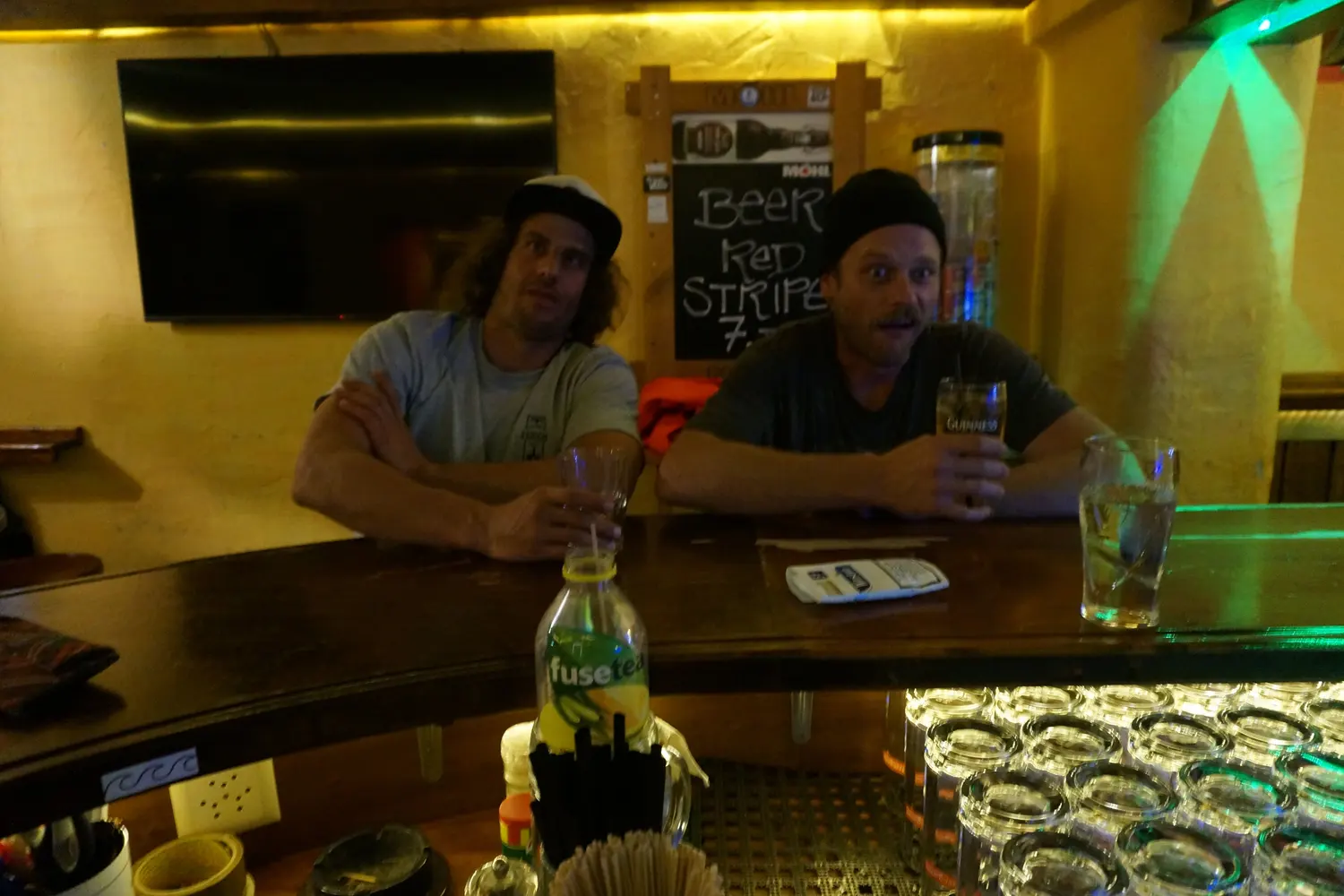 Two guests lean back at the counter